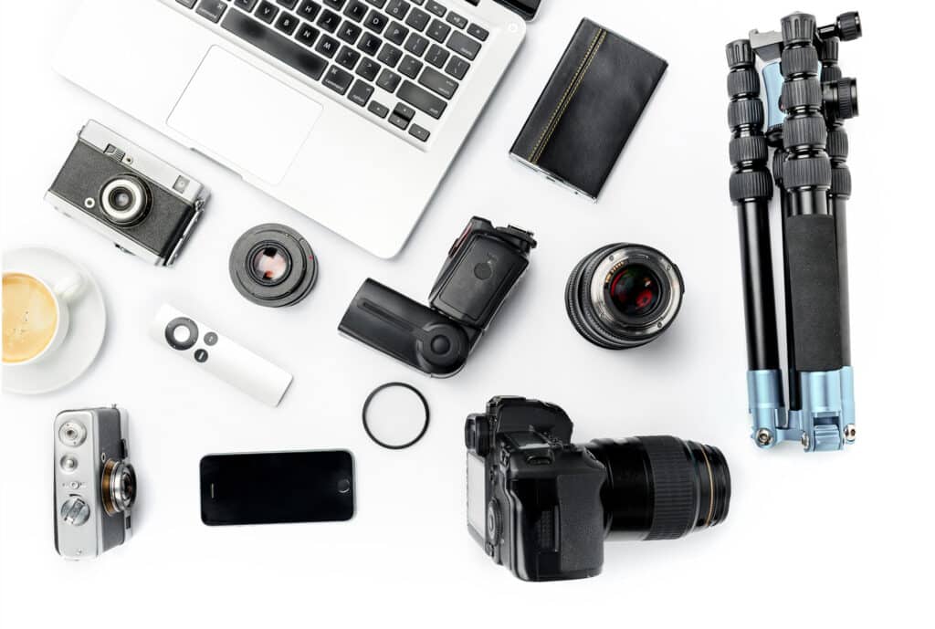 photography equipment including laptop, cameras, lenses, and tripod